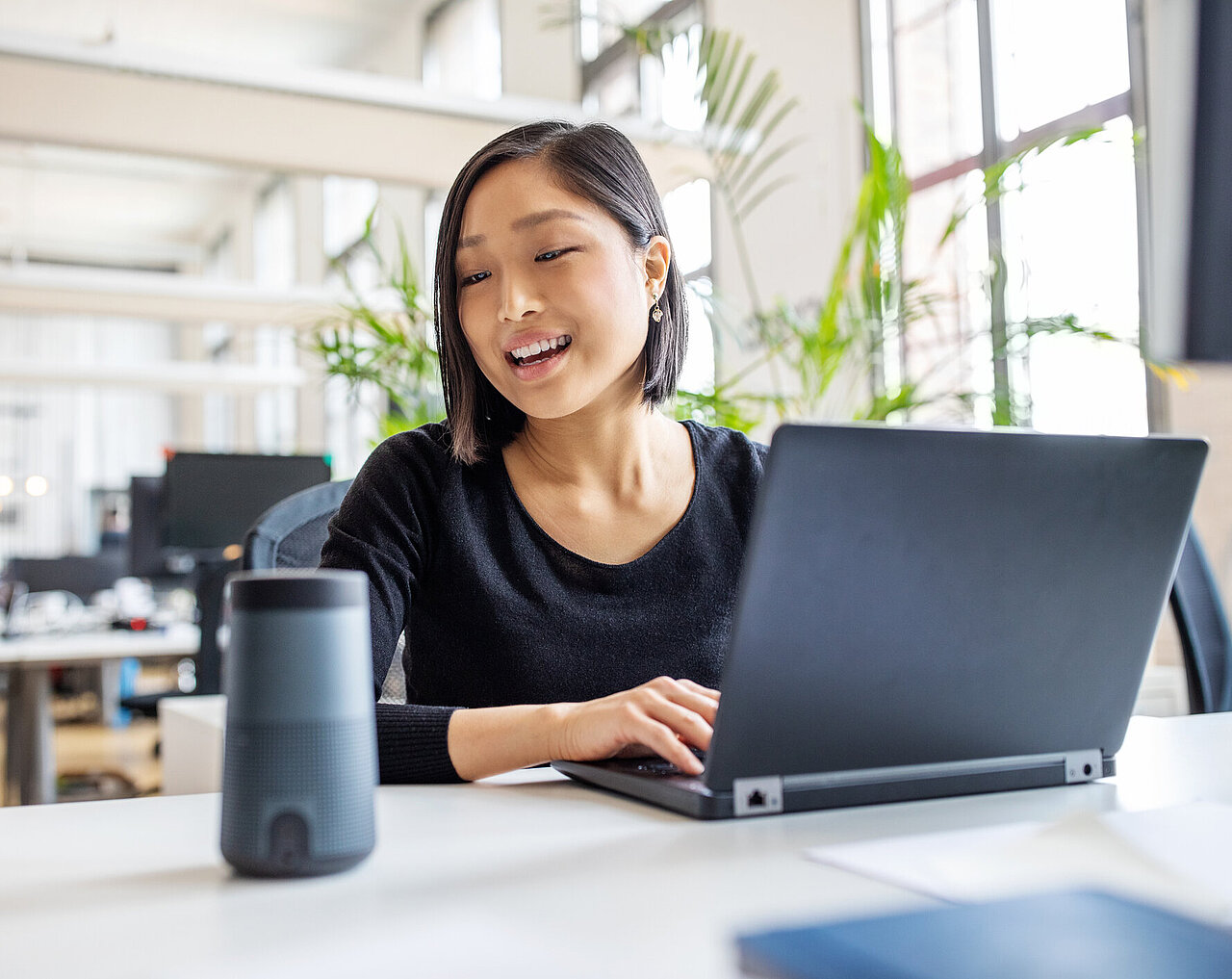 Woman speaking to her smart speaker