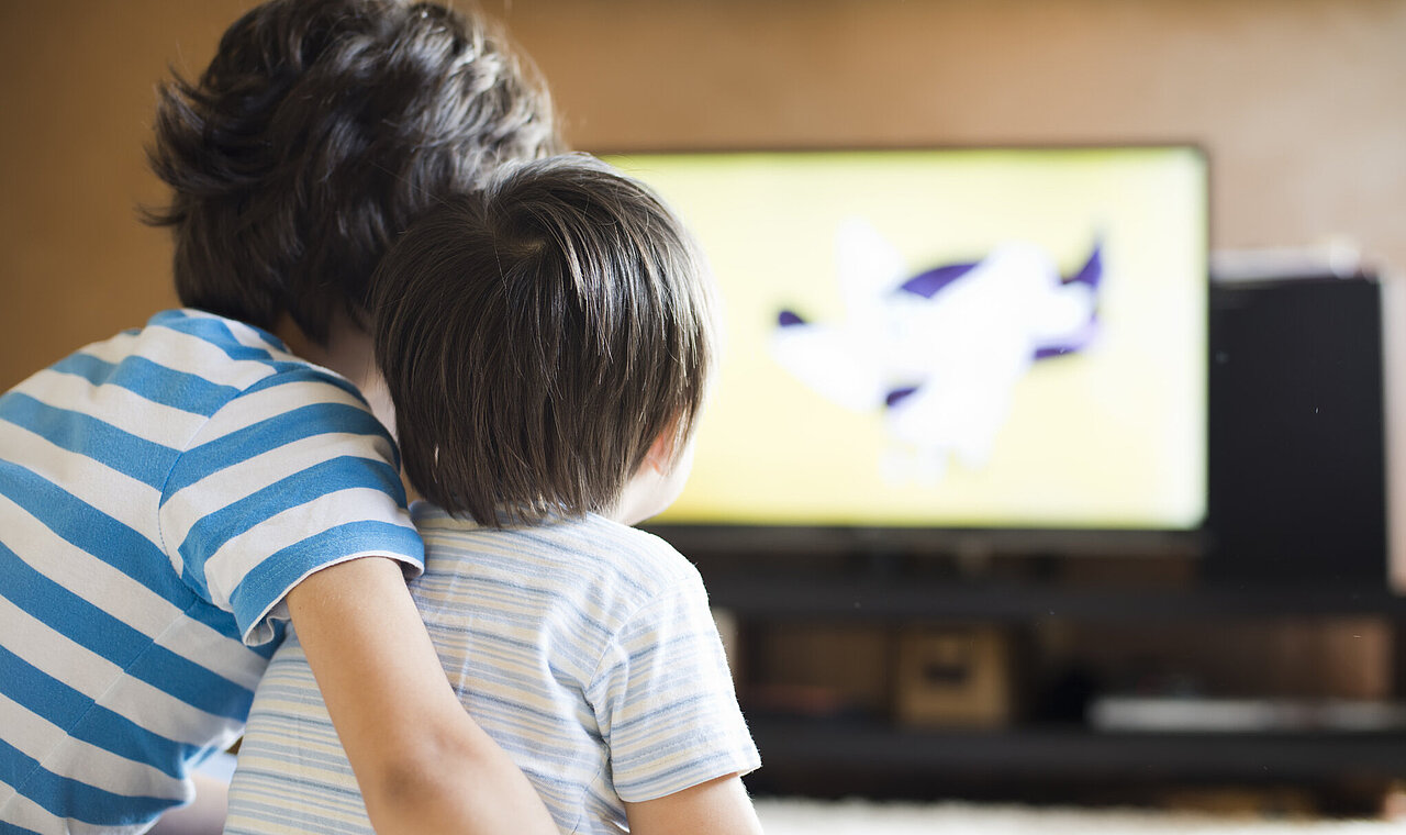 Two children watching TV