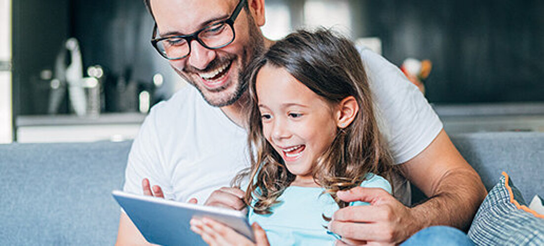 Father and child on tablet