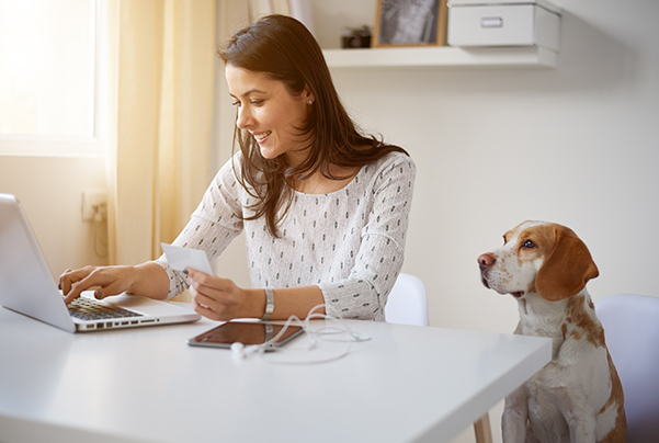 Happy woman paying bill online